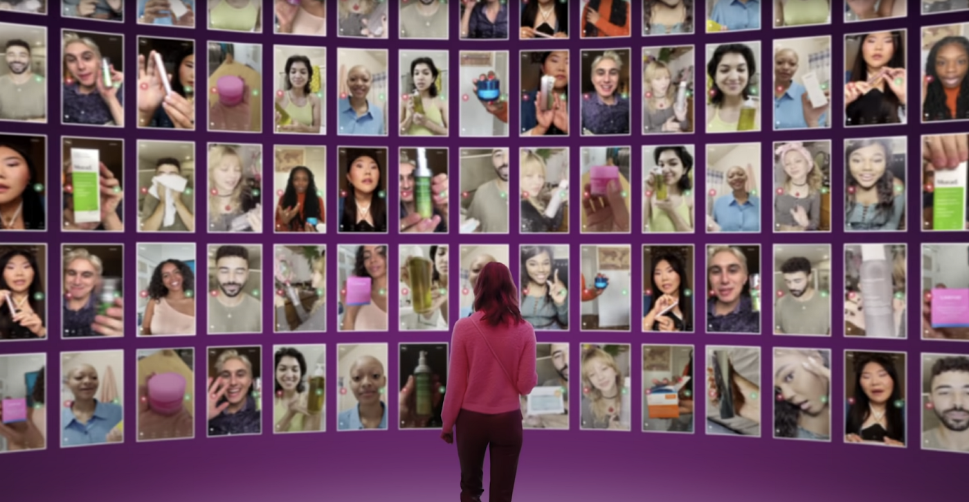 A women in purple shit standing in front of Flip app screens